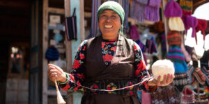 Sherpa lady spinning wool at Cholangpati on the Gosainkunda trail in Nepal