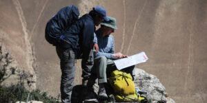 Guide and trekker looking at a Mustang map
