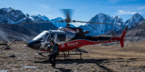 Happy photographer getting back on the heli for the return flight from the Khumbu region in Nepal