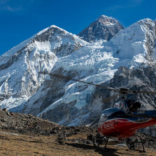 Helicopter on Kalapattar in front of Everest, photographer getting his shot on a heli sightseeing trip in Nepal