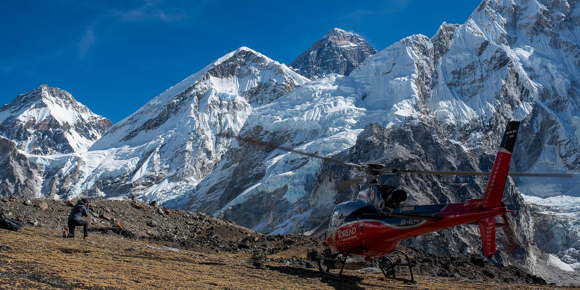 Helicopter on Kalapattar in front of Everest, photographer getting his shot on a heli sightseeing trip in Nepal