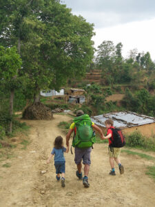 Guide trying to keep up with young trekkers between Panauti and Assapuri in Nepal