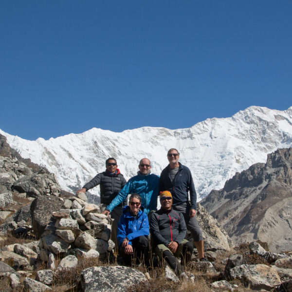 Group posing in front of Kanchenjunga at Oktang near the south Base camp in eastern Nepal