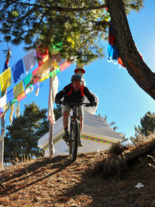 Mountian biker coming down from the Milarepa caves above the Manang valley in Nepal