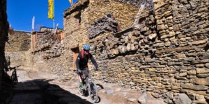 Riding through the ancient village of Ngawal in the Manang valley on the Annapurna circuit in Nepal