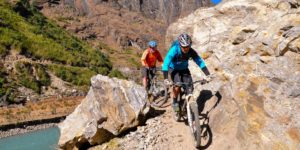 Mountain bikers on the trail between Tal and Dharapani on the Annapurna circuit above the Marshyangdi river in Nepal