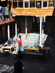 Bikes and riders in a tea house courtyard in Manang on the Annapurna circuit in Nepal