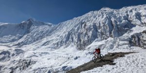 Rider starting to descend from Tilicho Lake on the Annapurna circuit. Gangapurna peak and the Tilicho wall in seen in the background