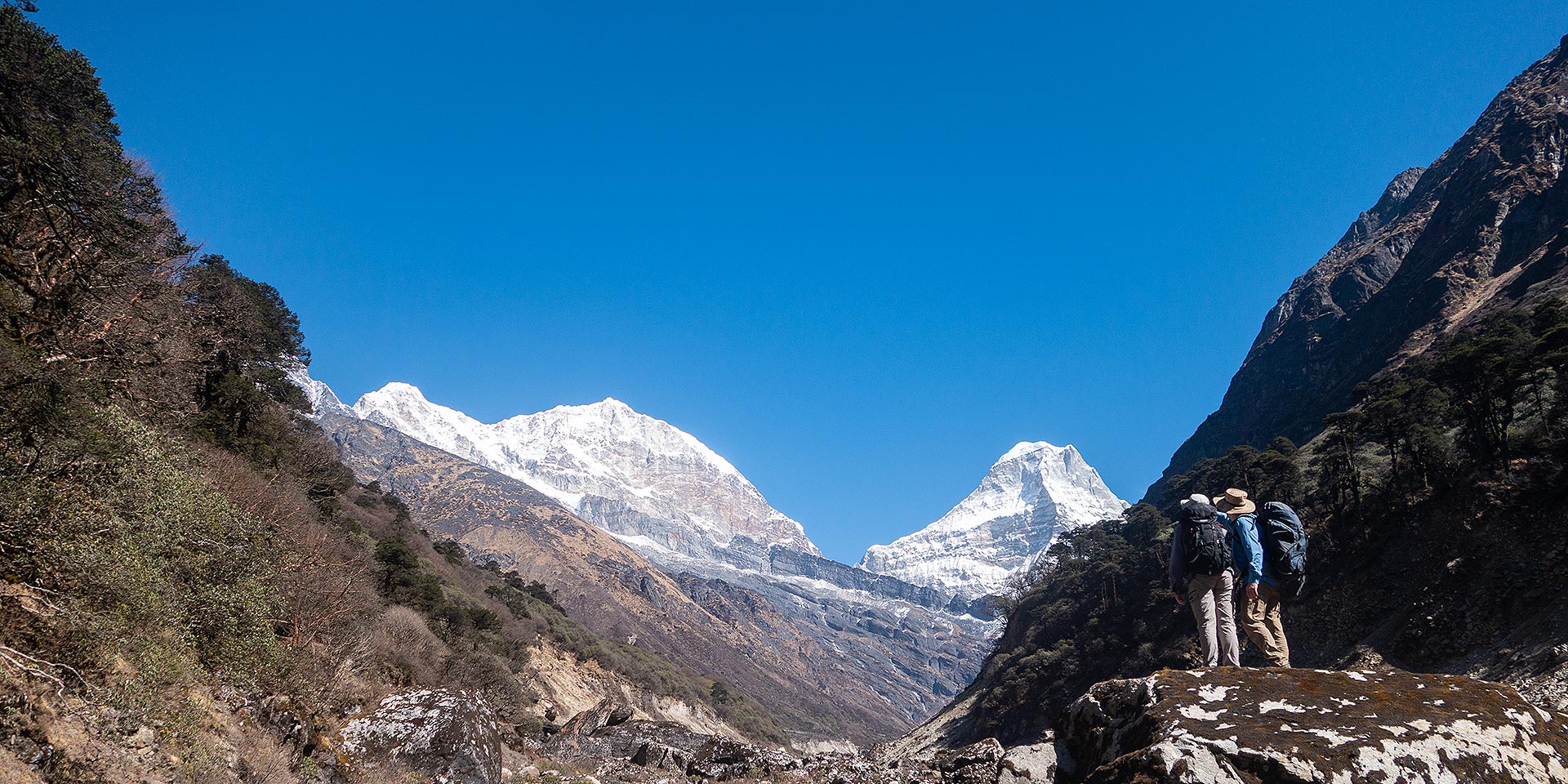 Trekkers enjoying the view of Kusum Kanggaru 6367m and Kyashar 6769m on the Mera trail in the Hinku Valley, Nepal