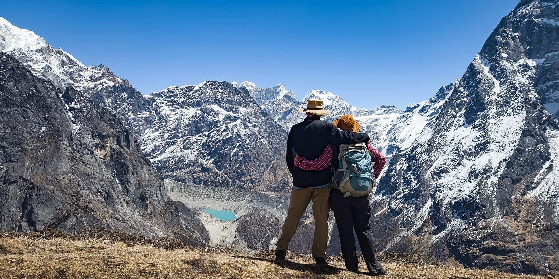 Trekkers enjoying the view from the ridge above Thangnak. The glacial lake is Sabai Tsho. Mt Chanlang 7319m can be seen in the background. This is in the Hinku valley of the Makalu Barun national park in Nepal