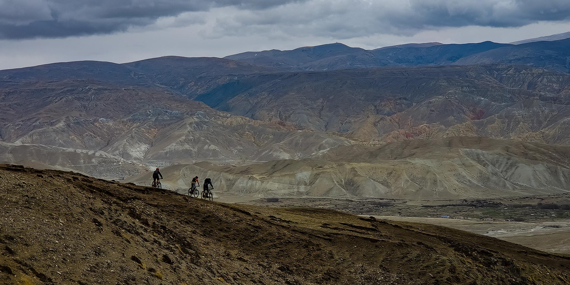 Riders descending from the Mustang golf course to Thinkar village in Upper Mustang, Nepal